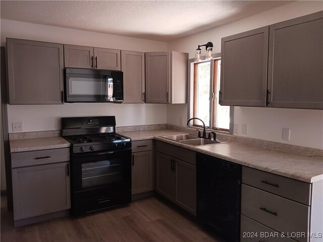 607 N Hughes Ave, Stover, MO 65078 - kitchen with black appliances, a sink, dark wood-style floors, gray cabinetry, and a textured ceiling