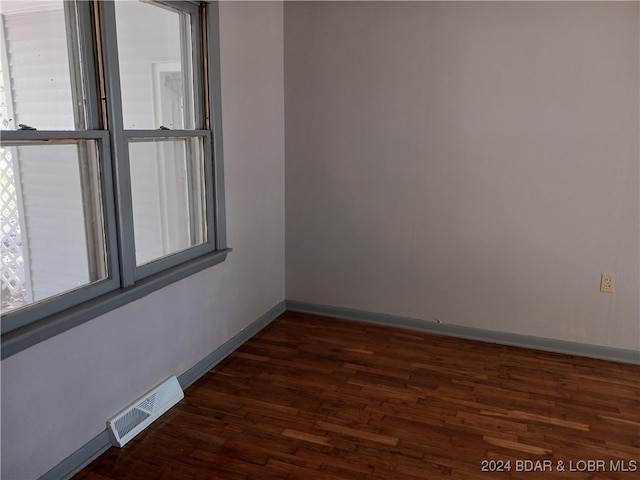 empty room featuring dark hardwood / wood-style flooring