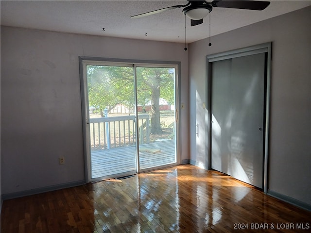 unfurnished room with a textured ceiling, hardwood / wood-style flooring, and ceiling fan