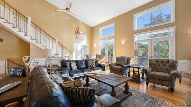 living room with french doors, wood-type flooring, high vaulted ceiling, and ceiling fan