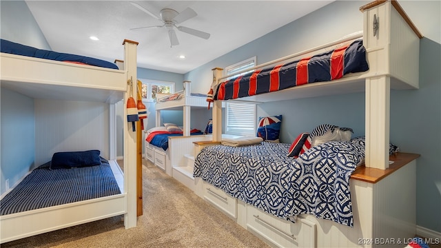 bedroom featuring light colored carpet and ceiling fan