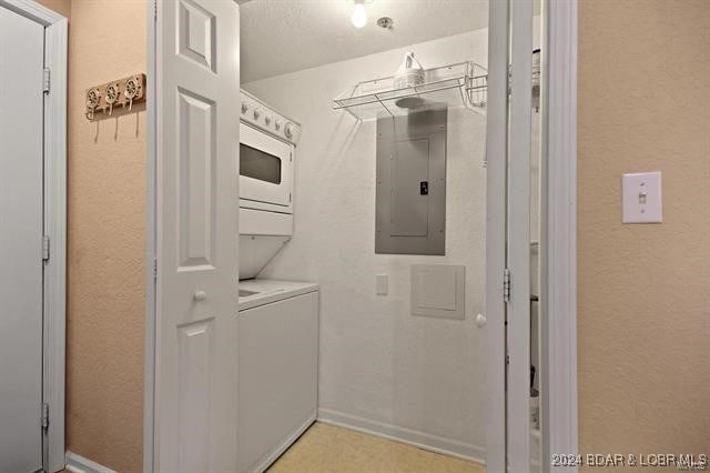 611 Lazy Days Rd Unit X11, Osage Beach, MO 65065 - laundry area featuring laundry area, stacked washer and clothes dryer, a textured wall, baseboards, and electric panel