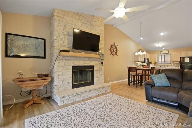 611 Lazy Days Rd Unit X11, Osage Beach, MO 65065 - living room featuring baseboards, a fireplace, a ceiling fan, and light wood-style flooring