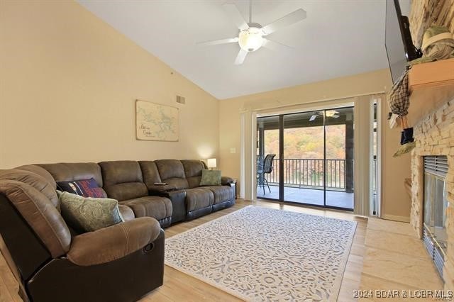 611 Lazy Days Rd Unit X11, Osage Beach, MO 65065 - living area featuring ceiling fan, light wood-style flooring, high vaulted ceiling, and a fireplace