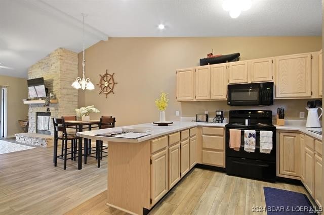 kitchen featuring vaulted ceiling with beams, light hardwood / wood-style flooring, black appliances, and kitchen peninsula