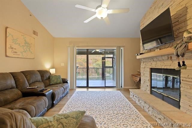 611 Lazy Days Rd Unit X11, Osage Beach, MO 65065 - living area with light wood-style floors, ceiling fan, vaulted ceiling, and a stone fireplace