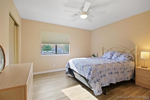 611 Lazy Days Rd Unit X11, Osage Beach, MO 65065 - bedroom with a ceiling fan, baseboards, light wood-style flooring, and a closet