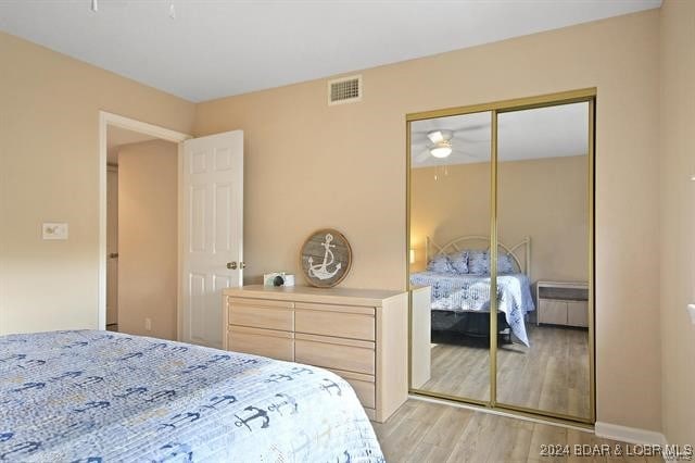 bedroom featuring a closet and light hardwood / wood-style flooring