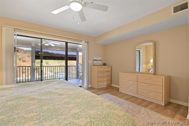 611 Lazy Days Rd Unit X11, Osage Beach, MO 65065 - bedroom featuring baseboards, access to exterior, light wood-style flooring, and visible vents