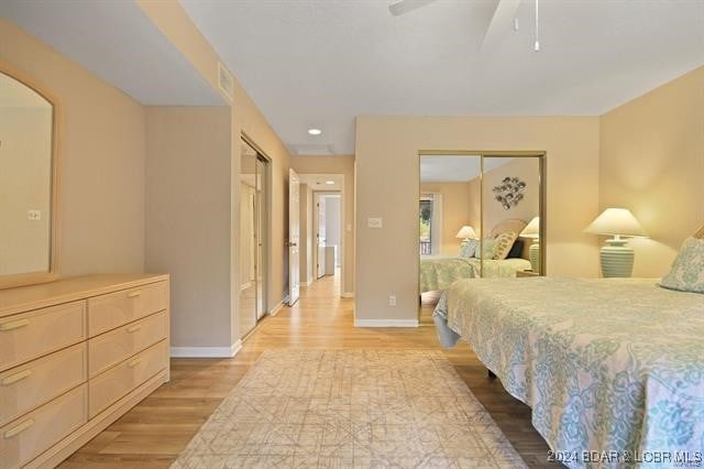 611 Lazy Days Rd Unit X11, Osage Beach, MO 65065 - bedroom with baseboards, a ceiling fan, arched walkways, and light wood-style flooring