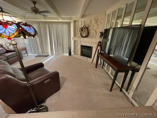 living room featuring ceiling fan and a fireplace