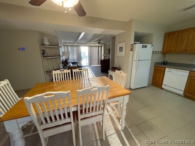 tiled dining area featuring ceiling fan