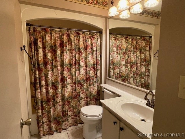 bathroom with vanity, toilet, and tile patterned floors