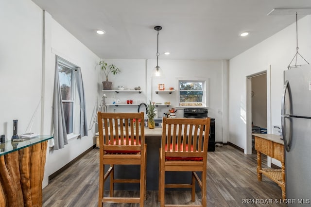 dining space with dark hardwood / wood-style floors