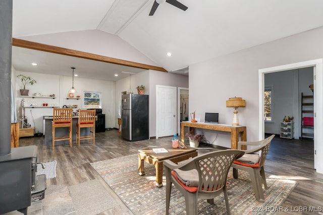 living room featuring dark hardwood / wood-style flooring, ceiling fan, and vaulted ceiling