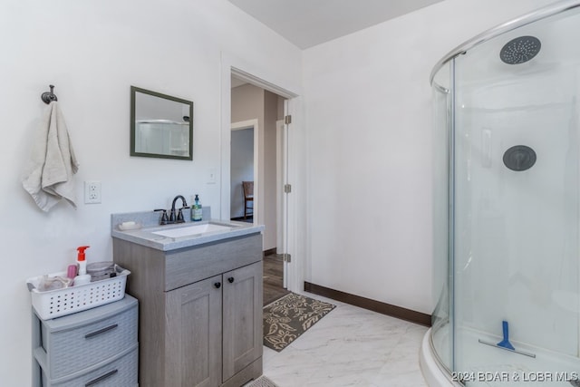 bathroom featuring vanity and a shower with door