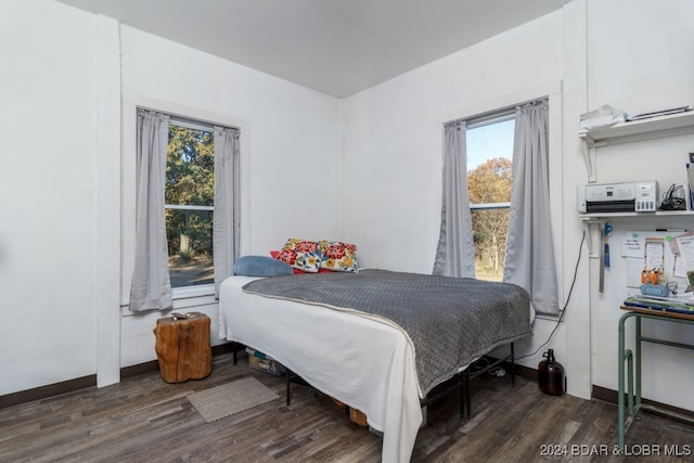 bedroom with dark hardwood / wood-style flooring