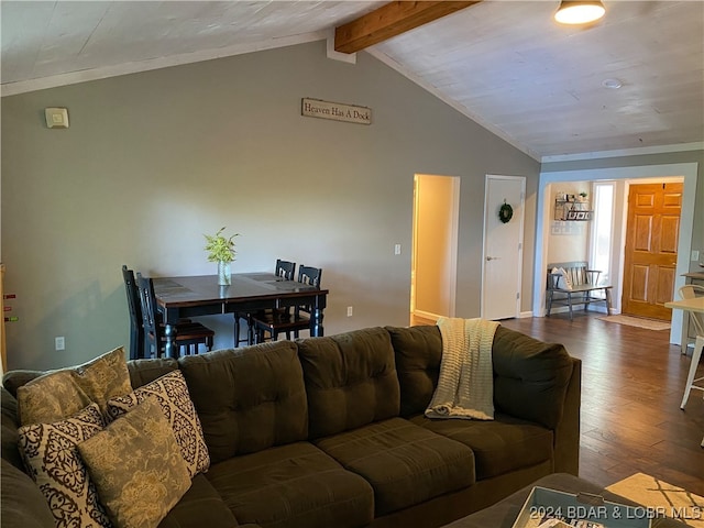 living room with hardwood / wood-style flooring and vaulted ceiling with beams