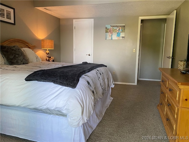 carpeted bedroom featuring a textured ceiling