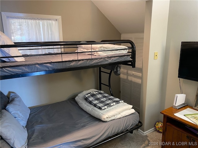 bedroom featuring carpet and vaulted ceiling