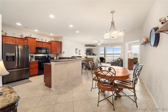 kitchen with ceiling fan with notable chandelier, stainless steel refrigerator with ice dispenser, electric range, light tile patterned floors, and decorative light fixtures