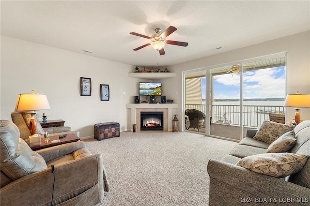 carpeted living room with ceiling fan