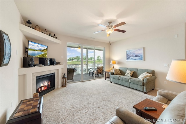 carpeted living room featuring ceiling fan