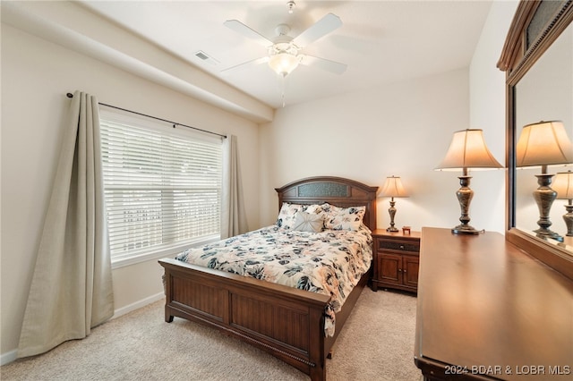 bedroom with ceiling fan and light colored carpet