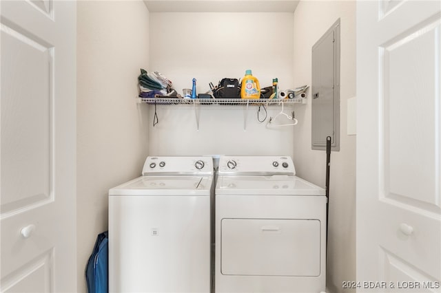 laundry room with washing machine and dryer and electric panel