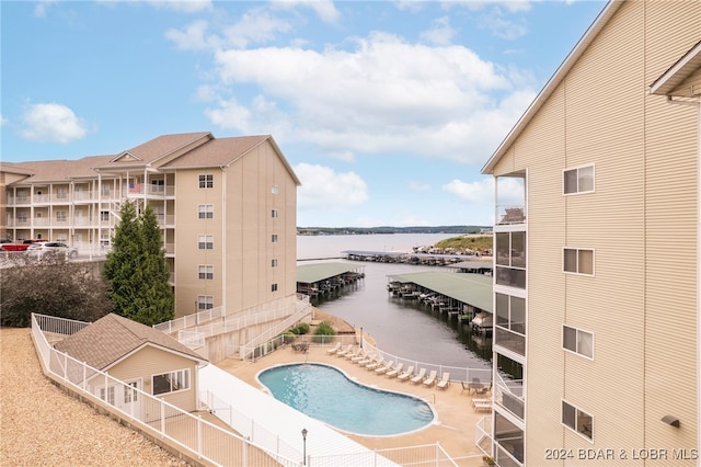 view of swimming pool featuring a water view