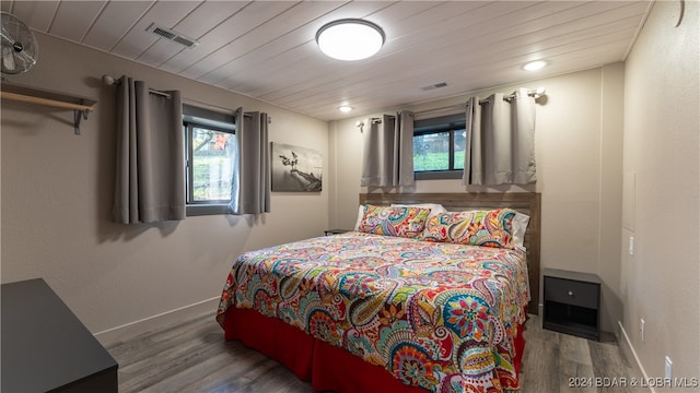 bedroom featuring wood-type flooring and wooden ceiling