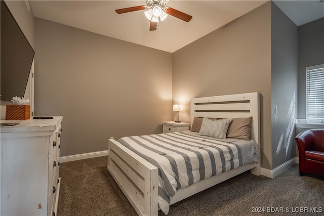 bedroom with dark colored carpet, vaulted ceiling, and ceiling fan