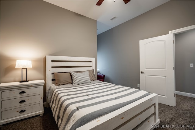 bedroom featuring dark carpet and ceiling fan