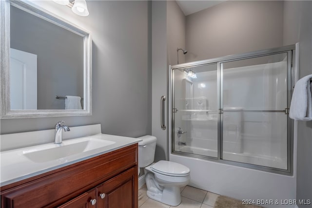 full bathroom featuring vanity, toilet, enclosed tub / shower combo, and tile patterned flooring