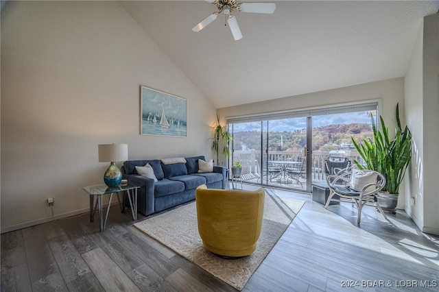 living room featuring ceiling fan, high vaulted ceiling, and hardwood / wood-style floors