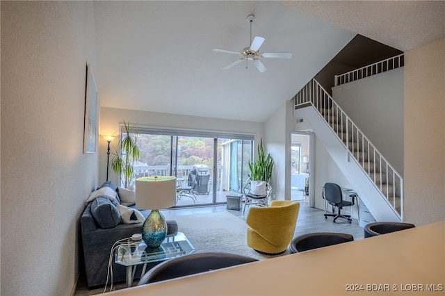 carpeted living room featuring high vaulted ceiling and ceiling fan