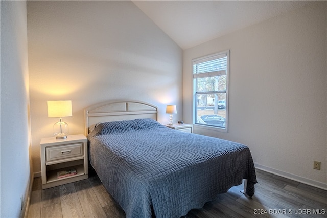 bedroom with lofted ceiling and dark hardwood / wood-style flooring