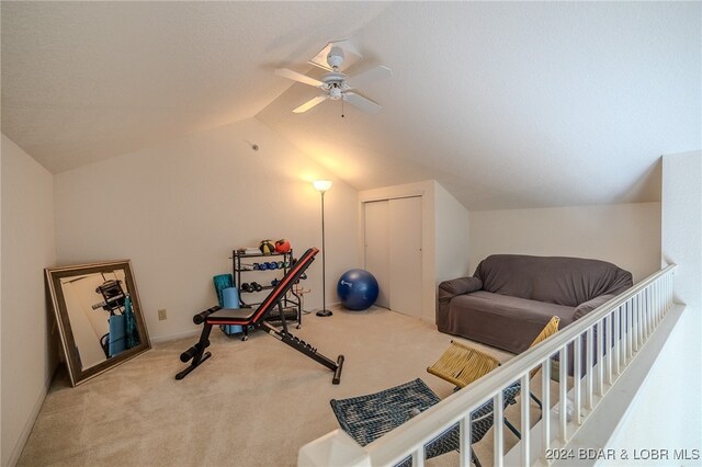 exercise area with vaulted ceiling, light carpet, and ceiling fan