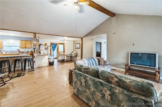 living room featuring beam ceiling, light hardwood / wood-style flooring, high vaulted ceiling, and ceiling fan