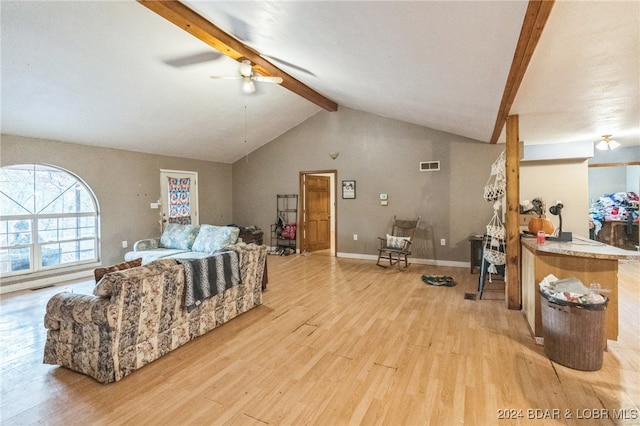 living room with vaulted ceiling with beams, light wood-type flooring, and ceiling fan