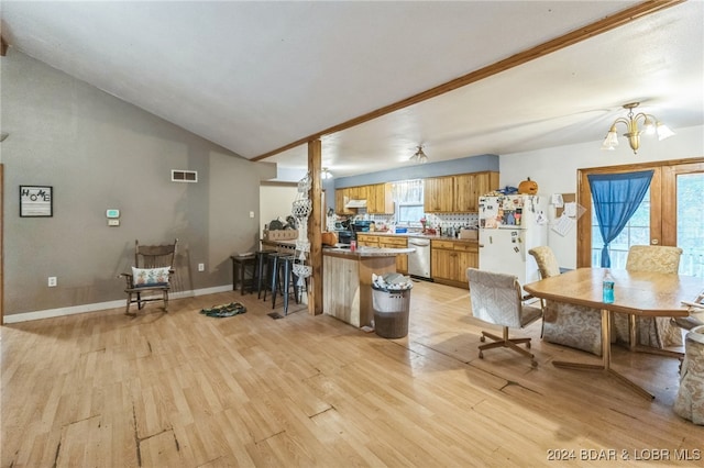 kitchen featuring white fridge, light wood-type flooring, dishwasher, and kitchen peninsula