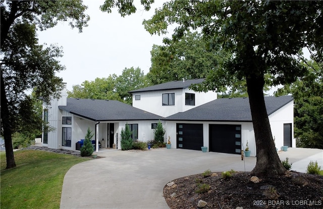 view of front of property featuring a garage and a front lawn