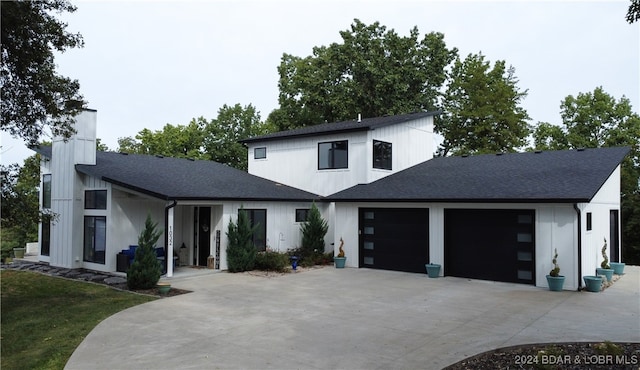 modern inspired farmhouse with a garage