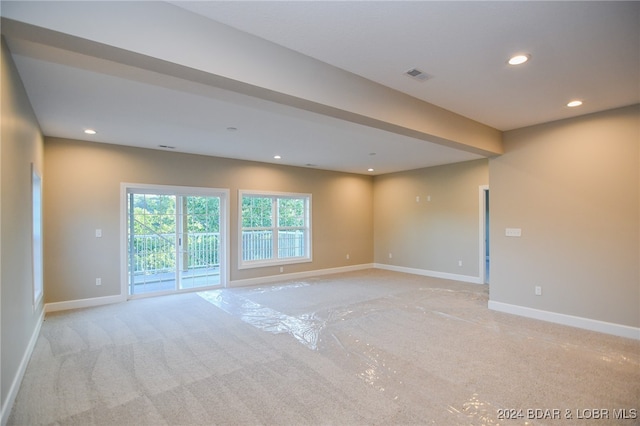 empty room featuring light carpet, recessed lighting, visible vents, and baseboards