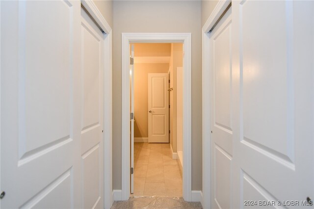 hall with light tile patterned floors