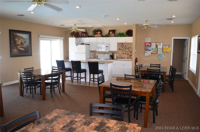 dining space featuring baseboards, a ceiling fan, and recessed lighting