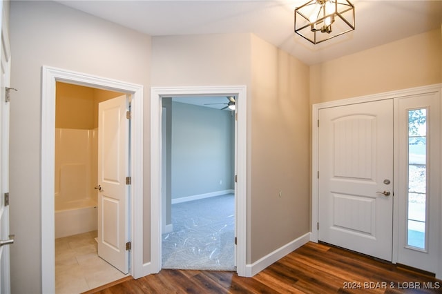 foyer with dark hardwood / wood-style floors and an inviting chandelier