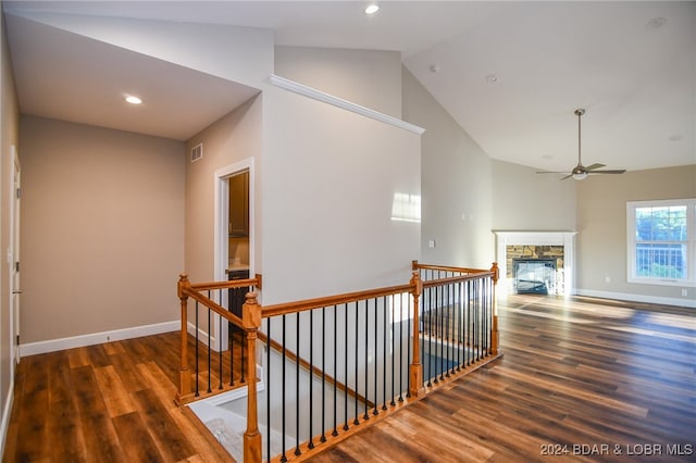 hallway featuring high vaulted ceiling and dark hardwood / wood-style flooring