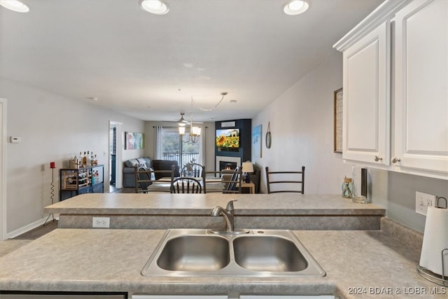 kitchen featuring white cabinetry and sink