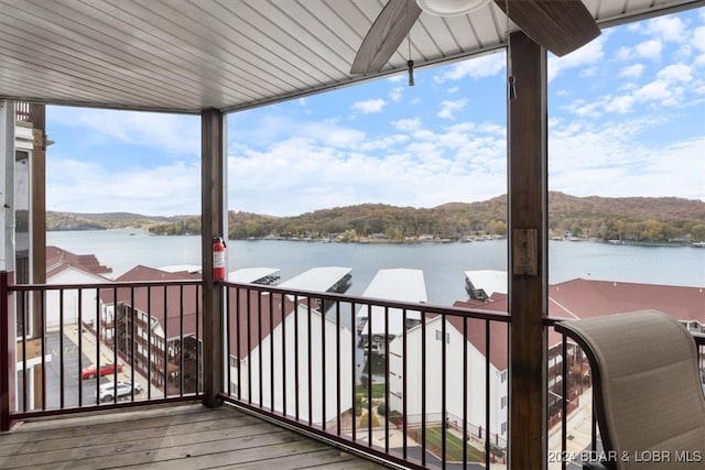 view of dock featuring a water view and a balcony